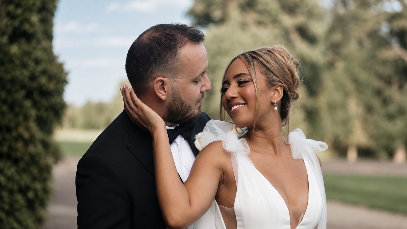 Bride smiling with her hand on the groom's face